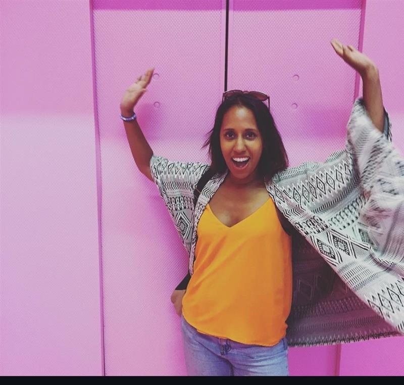 Zena Zerai, arms up, full energy, big smile